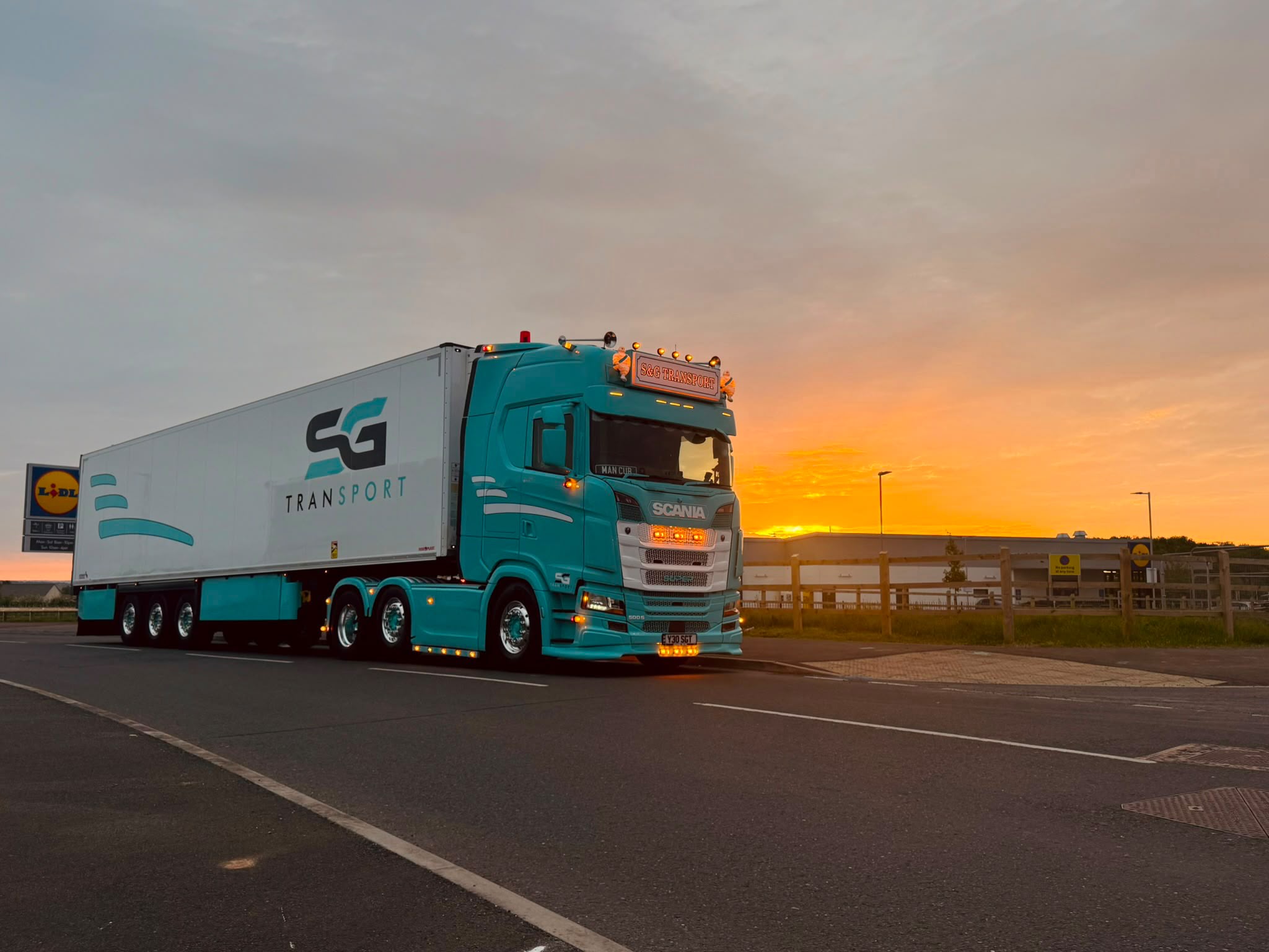 Two S&G Transport vehicles at sunset
